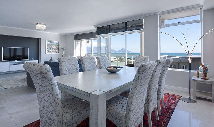 dining room with windows in view and a large TV
