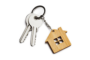 2 keys with wooden house key ring