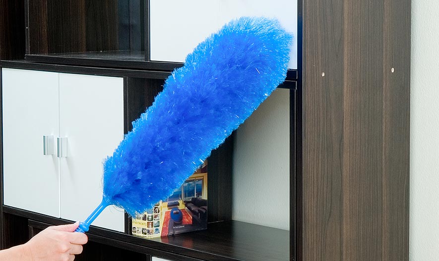 duster cleaning a display cabinet