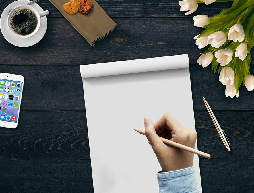 hand with pencil and pad and paper